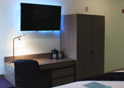 Hotel room with flatscreen TV and lighted desk